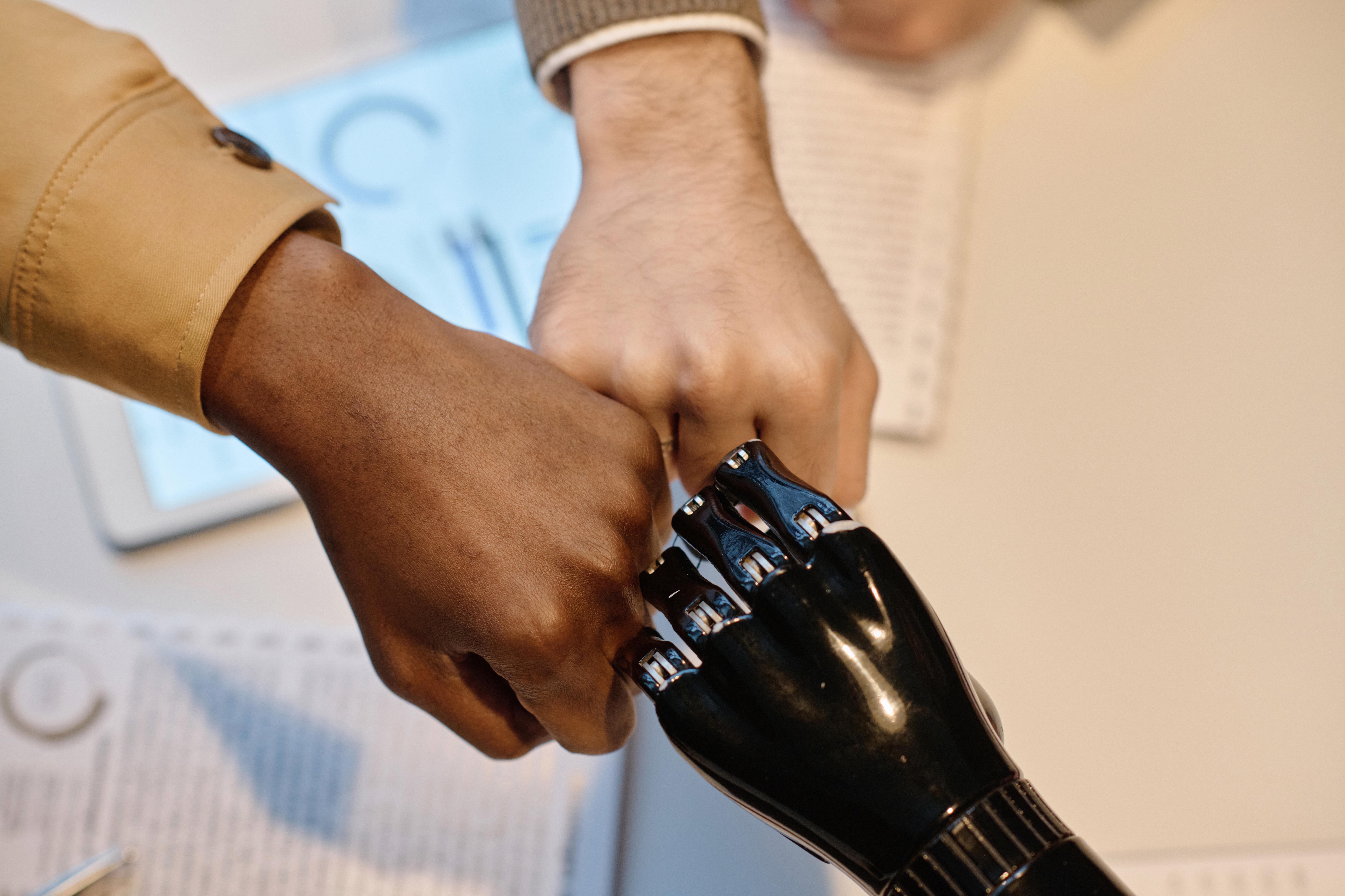 A robot fistbumping with business development professionals